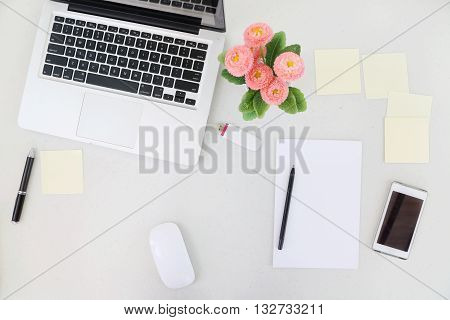 Creative Chaos. A high angle view of laptop, blank paper and lots of sticky notes around