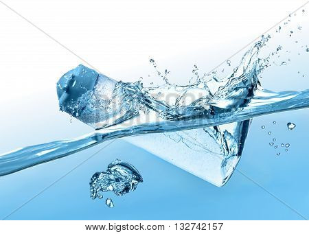 The flacon of moisturizing shampoo, cosmetic liquid, tonic falls into the blue water with big water splash