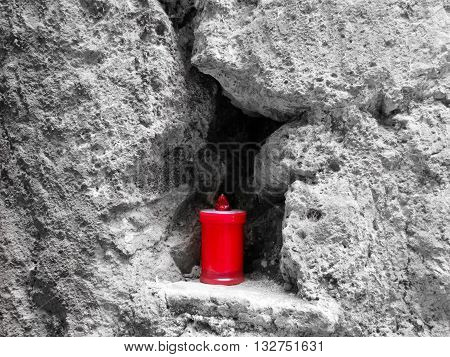 lumino embedded in rock in Calcata reminiscent of a saint