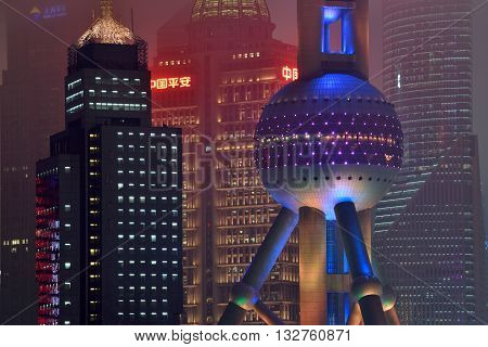 SHANGHAI CHINA - MARCH 19: Pudong district night view from Suzhou Creek on March 19 2016 in Shanghai China. Pudong is a district of Shanghai located east of the Huangpu River.