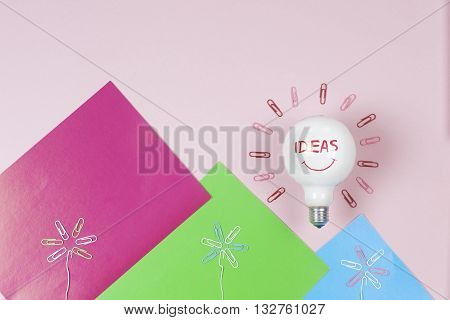 great idea concept with crumpled colorful paper and light bulb on light background. Creative brainstorm concept business idea. female hand holding light bulb. Copy space for text.
