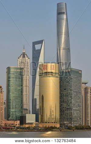 SHANGHAI CHINA - MARCH 25: Pudong district skyscrapers view from The Bund waterfront area on March 25 2016 in Shanghai China. Pudong is a district of Shanghai located east of the Huangpu River.