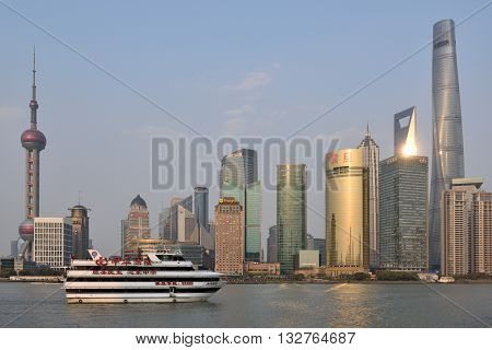 SHANGHAI CHINA - MARCH 25: Pudong district skyscrapers view from The Bund waterfront area on March 25 2016 in Shanghai China. Pudong is a district of Shanghai located east of the Huangpu River.