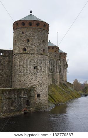 The building of the towers of the old medieval Olavinlinna castle in a cloudy autumn day. Finland