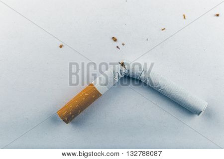 Quit Smoking - Low Contrast Image Of A Broken Unsmoked Cigarette Over White Background