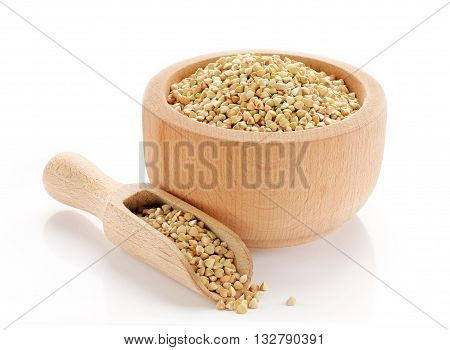 Organic green buckwheat in wooden bowl isolated on white background