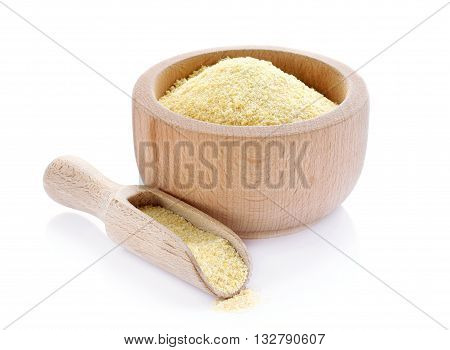 Corn grits in wooden bowl isolated on white background