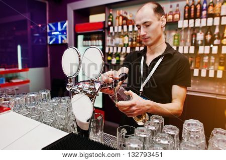 Bartender Pours A Beer At The Bar In The Club