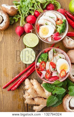 Asian ramen noodle soup with fresh veggies and hardboiled egg