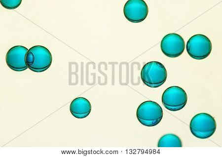 Some big blue air bubbles float over a light background