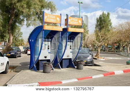 Tel Aviv-Yafo, Israel - January 21, 2016: Two electronic payment machines in huge parking lot in Tel Aviv beach area.
