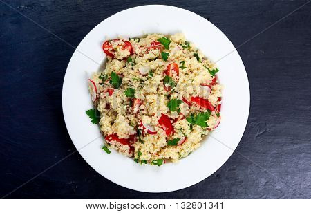 Homemade Fresh Couscous salad with vegetables, in white plate