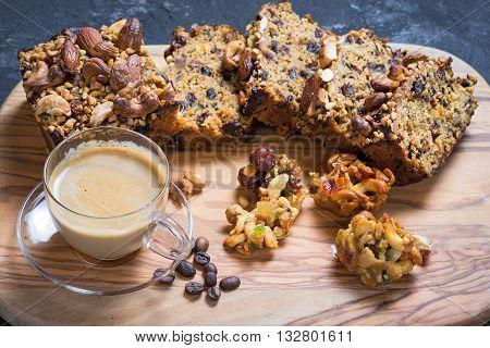Cup of coffee with cookies and coffee beans lying on the wooden stand