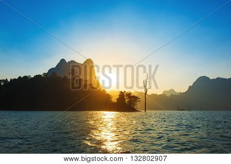Sunset behind mountain and blue sky at Khaosok Lake Thailand