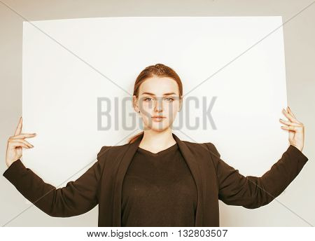 young pretty brunette girl with placard shit copyspace on white background wearing business costume student