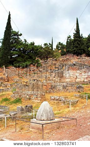 The view on Omphalos or Baetylus, the famous religious stone artifact that was the center of the Universe for ancient greeks, Delphi, Greece
