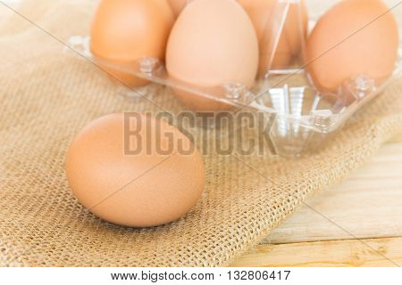 Eggs with heap on wood table background