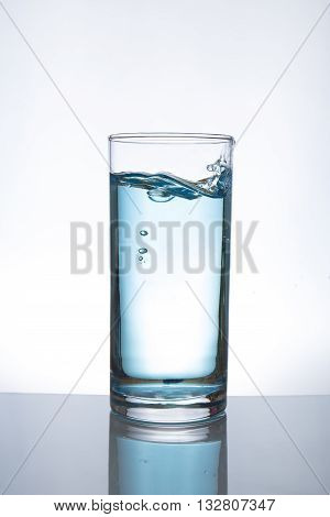 Concept of drinking. Pouring water from into glass