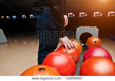 Close Up Of Bowling Player Hand Taking Red Ball From Bowl Lift