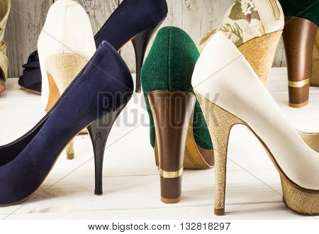 various womens shoes on wooden background, different style