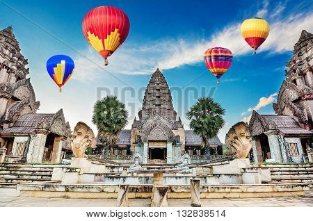 Hot-air balloons flying over blue sky at Ancient Bayon castle, Angkor Thom, Chiangrai, Thailand.