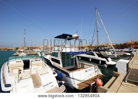 PUERTO SOTOGRANDE, SPAIN - JULY 18, 2008 - Yachts and boats in the marina with buildings to the rear Puerto Sotogrande Cadiz Province Andalucia Spain Western Europe, July 18, 2008.
