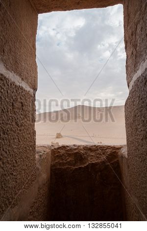 Desert view via a fortress window in Palmyra Syria. It is saddening that Palmyra's present Roman ruins declared by UNESCO as a world heritage site have come to be endangered in the 21st century by regional military and political strife.