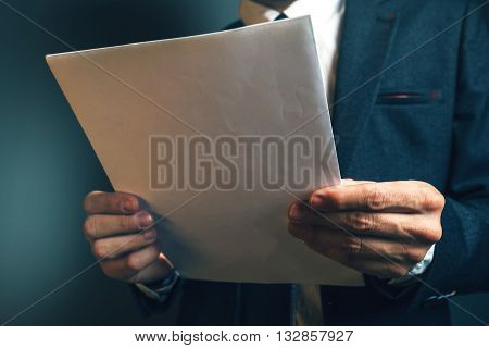 Lawyer reading legal contract agreement person in elegant business suit examining document.