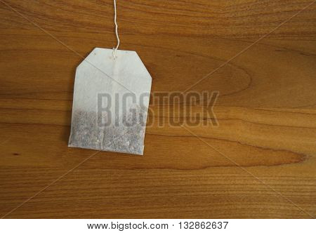 white tea bag on brown wood background