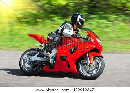 Dynamic and realistic motorbike racing on bright summer background