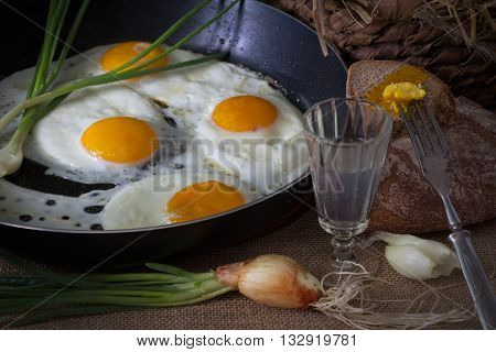Eggs fried in a pan  and green onion