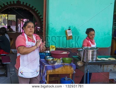 SUCHITOTO EL SALVADOR - MAY 07 : Salvadoran women prepares Popusas in Suchitoto El Salvador on May 07 2016. Popusa is a traditional Salvadoran dish made of corn tortilla