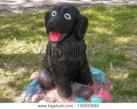 Black dog sculpture at the child playground