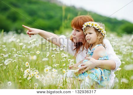 happy family having fun in daisy field