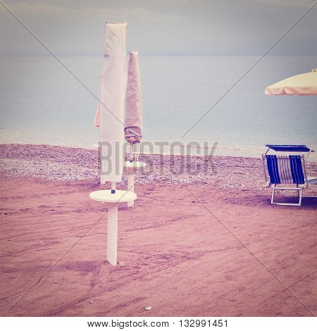 Beach Umbrella and Sun Bed in the Sandy Coast near the Italian City of Minori Retro Effect