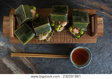Prawn Parsels With Shrimps In Banana Leaves. Dark Background. Asian Cuisine