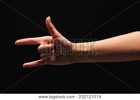 Female Hand Showing Rock Gesture Or I Love U Sign In Hand Language On Black Isolated Background. Cut