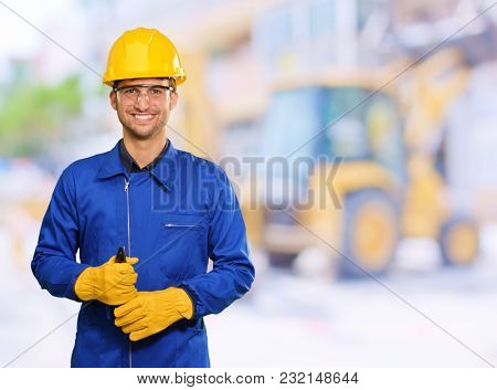 Portrait Of Engineer Holding Plier, Outdoors