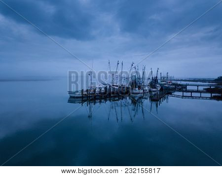 Low aerial view of shrimp boats in port in Port Royal, South Carolina.