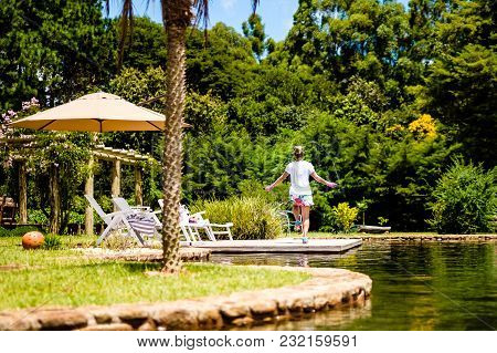 Attractive Young Woman Jumping Rope In Tranquil Location, Peaceful Lake With Garden. Cunha, Sao Paul