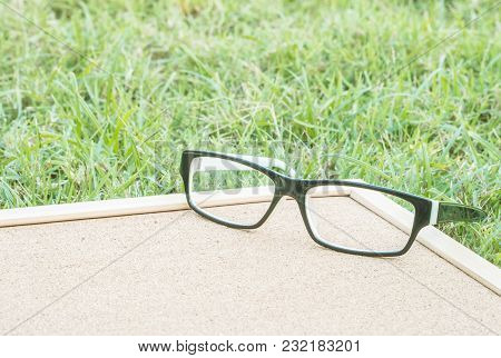 Closeup A Glasses On Cork Board Background