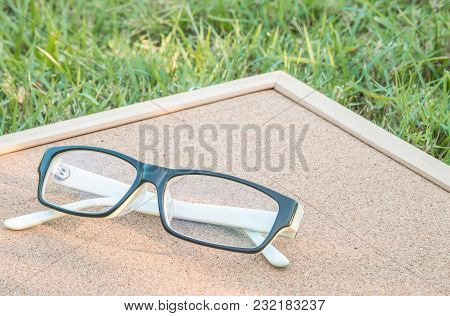 Closeup A Glasses On Cork Board Background