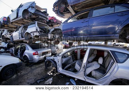 Piles Of Used And Damaged Cars Ar A Scrapheap Junkyard