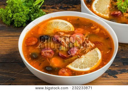 Thick And Hearty Russian Tomato Soup Solyanka With Turkey, Sausages, Pickled Cucumbers, Black Olives