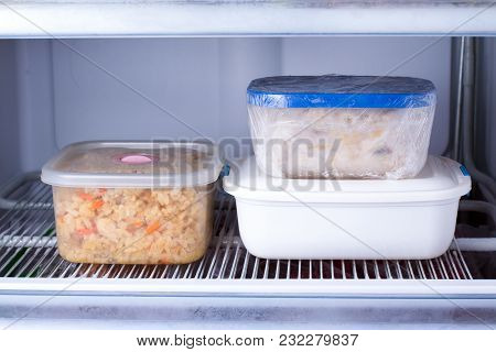 Frozen Food In A Container In The Freezer. Refrigerator With Frozen Food. Ready Meal