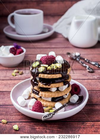 A Sweet Dessert Of Chocolate Biscuit, Raspberry Marshmallow And A Cup Of Coffee On Dark Background.