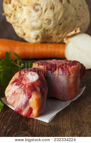 Raw Ox Tail With Ingredients On Dark Wood