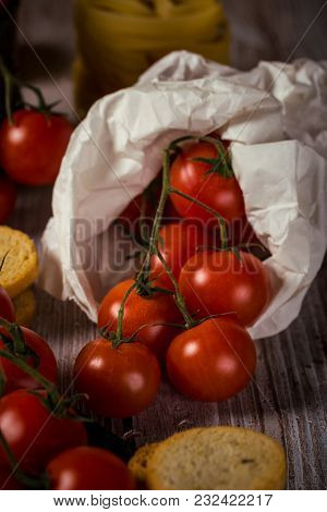 Small Cherry Tomatoes In Paper Bag With Bruschetta