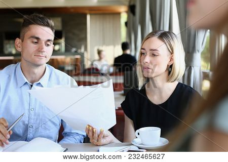 Businessmen Stady Documents In Cafe. Discuss Chart Report