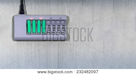 Environmentally Friendly Rechargable Batteries On A Charger